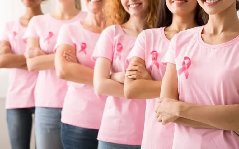 group of women wearing pink breast cancer awareness shirts